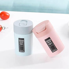 Load image into Gallery viewer, Two stylish toothpick holders in blue and pink, featuring sliding lids for easy dispensing and organized storage.
