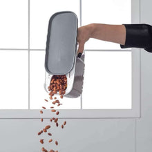 Load image into Gallery viewer, Hand pouring dry food from a grey sliding-lid container
