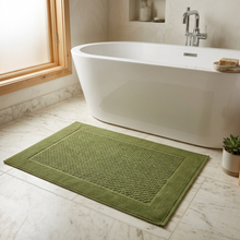Load image into Gallery viewer, Green bath mat with textured pattern on a white background
