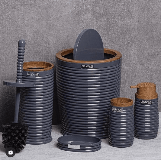 Set of gray and brown bathroom accessories with 'olympus' branding on a gray background