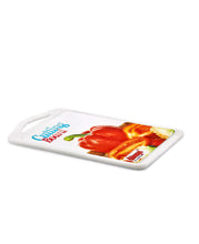 Load image into Gallery viewer, White cutting board with a colorful design of a red pepper and brand name on a white background
